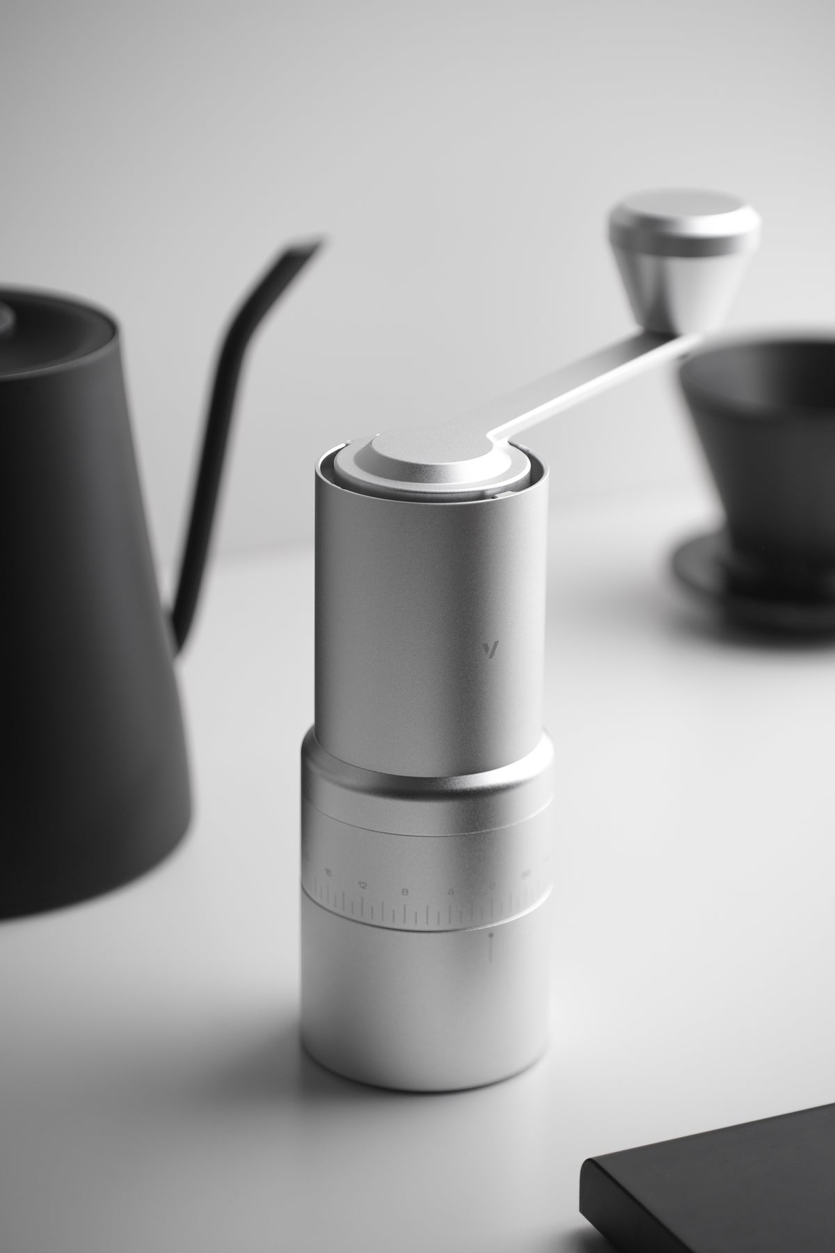 Current silver EVO Hand beside a home brewing setup