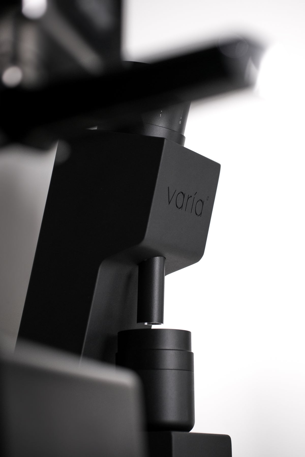 Side view of the black VS4 grinder, outlet and dosing cup