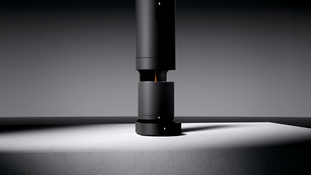 ORBI brewing espresso into its cup above the scale base