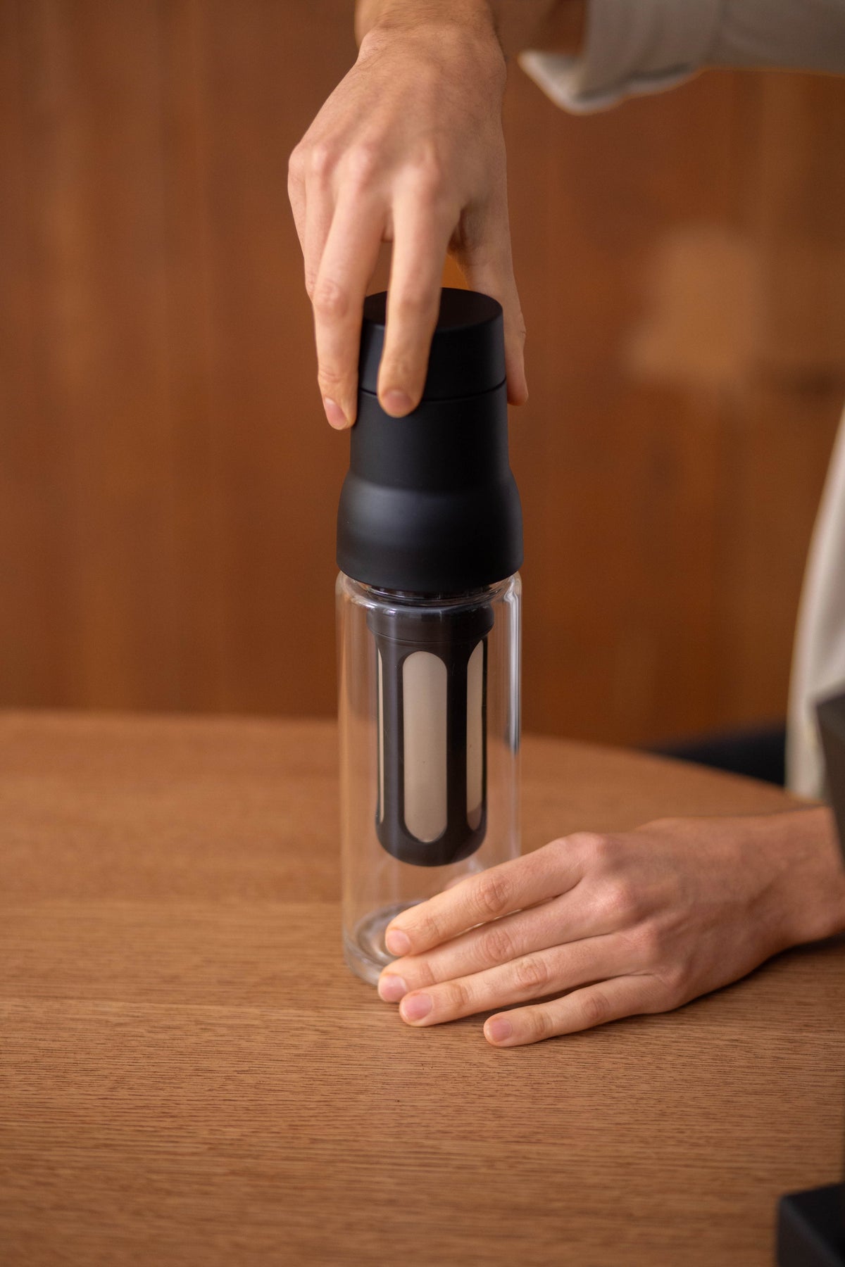 Lower the assembled filter into the glass bottle.