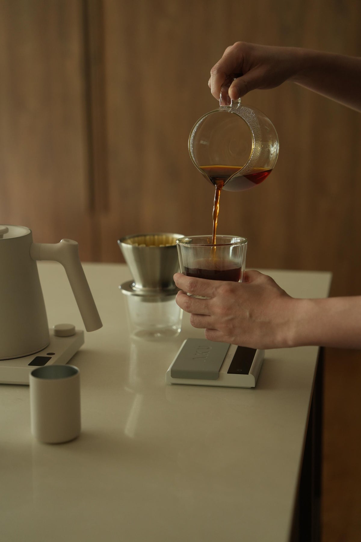 Pouring freshly brewed coffee at home with Varia brewing tools